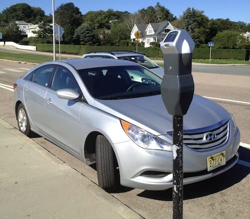 PARKED CORRECTLY: Vehicle is facing downhill.  Front tire is resting against the curb.