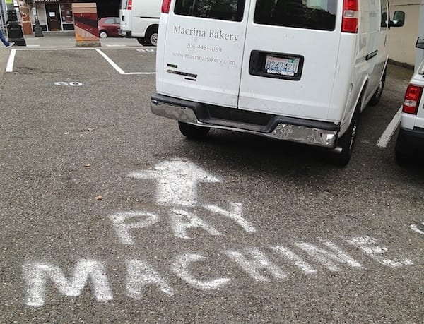 "Pay Machine" sign on the pavement.