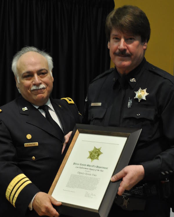 Sheriff Paul Pastor presenting Officer of the Year Award to Deputy Kevin Fries.