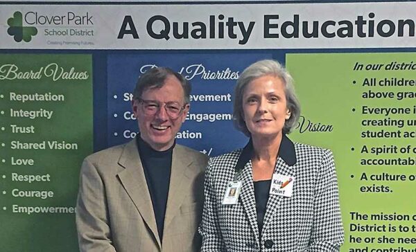 Joe Boyle - Contributor The Suburban Times (left) and Ms. Debbie LeBeau - Superintendent Clover Park Schools.  The background sign's message, "A Quality Education," is something Ms. LeBeau and I fully support.  After all, "Kids are the point."