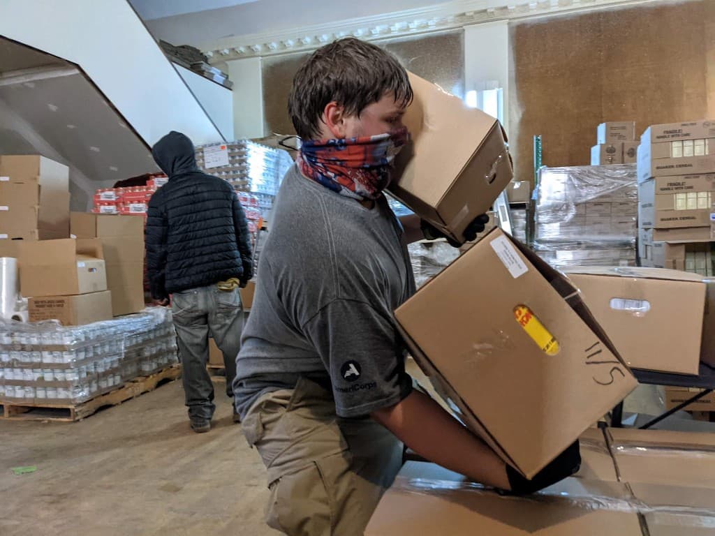 Volunteer carrying boxes